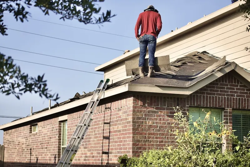 Professional roofer working on a residential roof in Coburnville